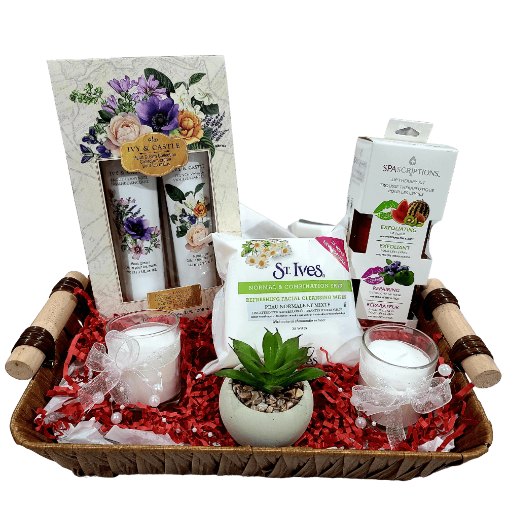 A gift basket containing decorative candles, hand cream collection, wipes, mini cologne spray, lip therapy kit, and an artificial flower pot, all arranged in a basket with a cellophane wrap.